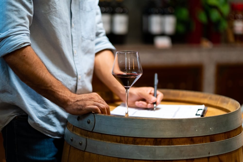 professional,man,sommelier,testing,red,wine,in,wine,glass,with